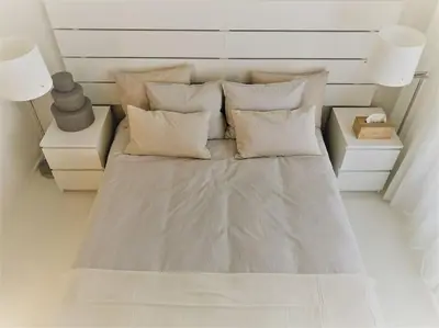 a bed in a room with two lamps and pillows at COCONUT MILK in Liège
