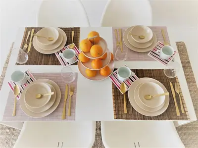 a table with plates and bowls of oranges on it at COCONUT MILK in Liège