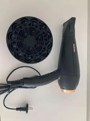 a black computer mouse sitting on top of a table at COCONUT MILK in Liège