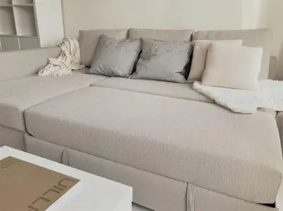 a couch with pillows on it in a living room at COCONUT MILK in Liège
