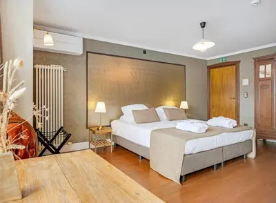 a large bedroom with two beds in a room at Café René Borgloon in Borgloon