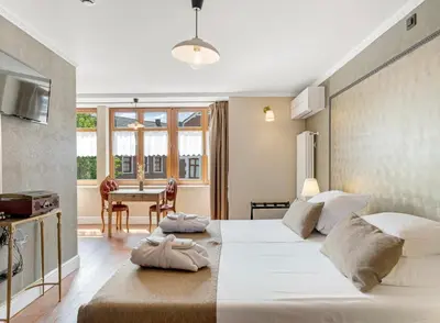 a bedroom with a large bed and a table at Café René Borgloon in Borgloon