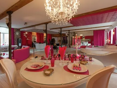 a dining room with a table and a chandelier at Cozy Stay with Pool & Nature in Ensival