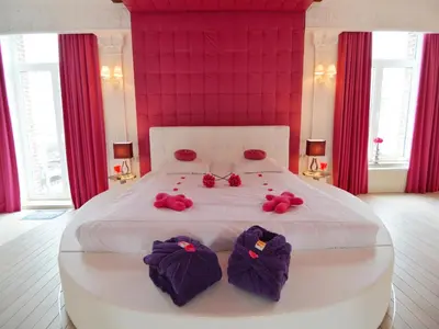 a bedroom with a large white bed with pink walls at Cozy Stay with Pool & Nature in Ensival