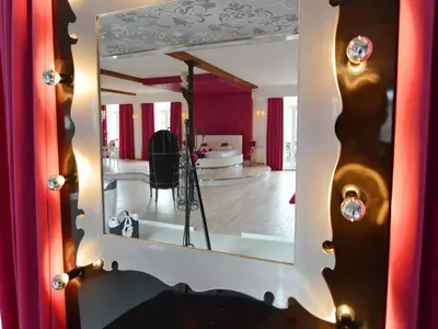 a mirror reflecting a room with a living room at Cozy Stay with Pool & Nature in Ensival