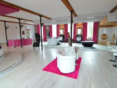 a living room with a pink rug and a table at Cozy Stay with Pool & Nature in Ensival