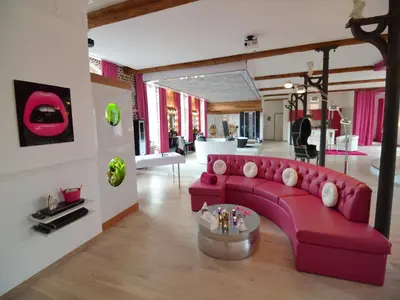 a living room with a pink couch and a table at Cozy Stay with Pool & Nature in Ensival