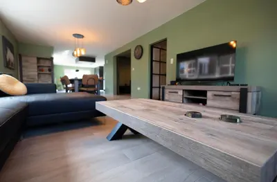 a living room with a couch and a coffee table at Vakantiewoning Het Kwartelnest Mettekoven (Heers) in Heers