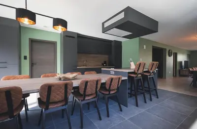 a kitchen with a large wooden table and chairs at Vakantiewoning Het Kwartelnest Mettekoven (Heers) in Heers