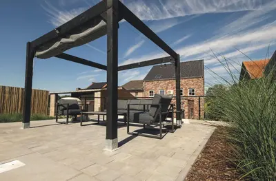 a gazebo with a table and chairs on a patio at Vakantiewoning Het Kwartelnest Mettekoven (Heers) in Heers