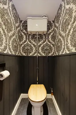 a bathroom with a toilet and a wallpaper at Bibi Tongeren in Tongeren