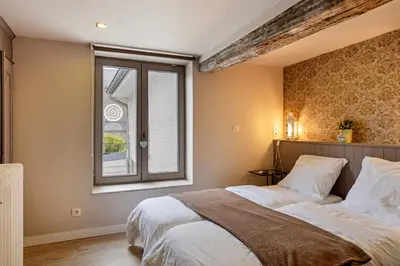 a bedroom with a large bed and a window at Bibi Tongeren in Tongeren