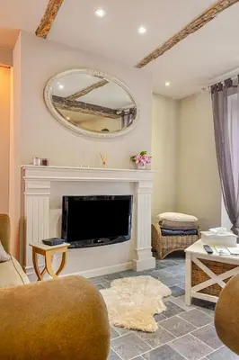 a living room with a fireplace and a mirror at Bibi Tongeren in Tongeren