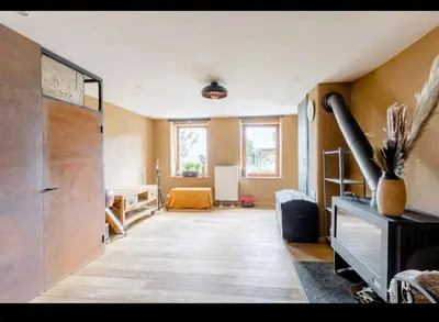 a room with a hallway with a large door and a table at Gee is Sharing her home in Liège