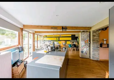 a kitchen with a counter and a refrigerator at Gee is Sharing her home in Liège