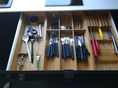 a wooden drawer filled with lots of utensils at Côté jardin in Dison