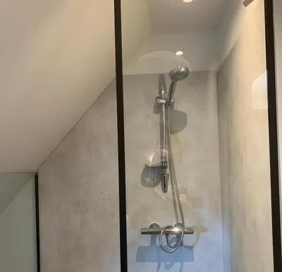 a shower in a bathroom with a glass door at Zolder appartement Le Grenier in Dilsen-Stokkem