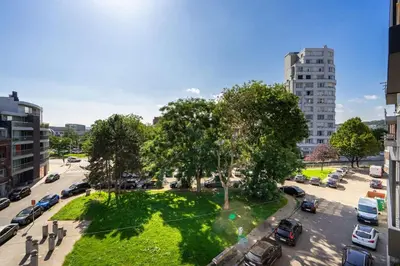 a park in the middle of a city at La Bohème in Liège