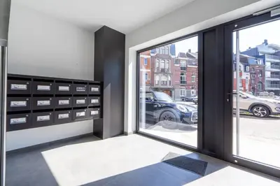 a room with a window with a view of a parking lot at La Bohème in Liège