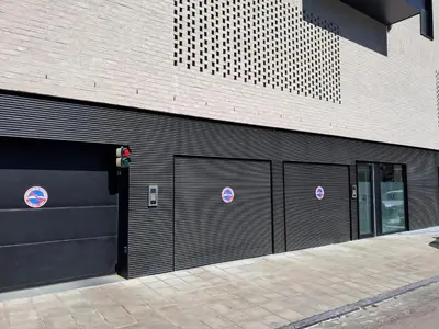 two garage doors with no parking signs on a building at La Bohème in Liège