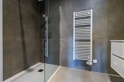 a bathroom with a shower with a glass door at La Bohème in Liège