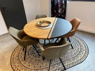 a wooden table and chairs on a rug at Les Quais de la Vesdre in Verviers