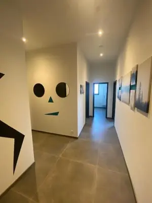 a hallway with a face painted on the wall at Les Quais de la Vesdre in Verviers