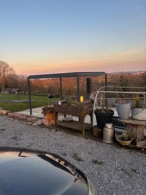 a car parked in front of a garden with a table at Le calme de la prairie de liège in Liège
