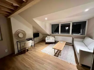a living room with a couch and a table at Maison avec 4 suites & Rooftop en plein centre ville - Place Saint Paul in Liège