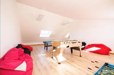 a room with a ping pong table in a attic at Li Mohone in Donceel