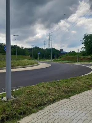 an empty road with a curve in the middle at Liege in Seraing