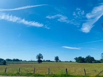 a field with a fence and a blue sky at Inova - Comfort Room with Private Bathroom and Shared Facilities in Hasselt