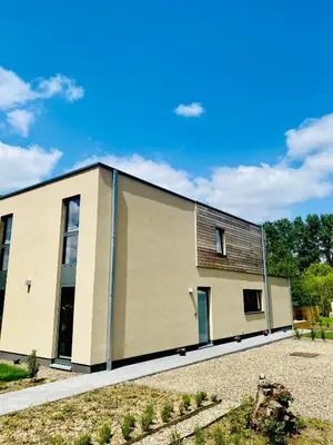 a large tan building with a roof at Inova - Comfort Room with Private Bathroom and Shared Facilities in Hasselt