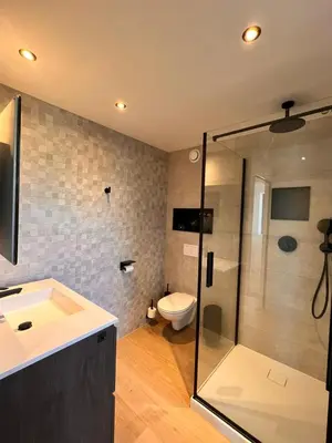 a bathroom with a shower and a sink and a toilet at Inova - Comfort Room with Private Bathroom and Shared Facilities in Hasselt
