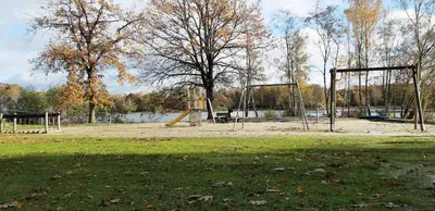 an empty park with a swing set and a playground at Zonnige vrijstaande bungalow in prachtige omgeving! in Rekem