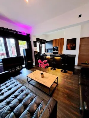 a living room with a couch and a coffee table at petite chambre dans une jolie colocation in Liège