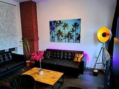 a living room with a couch and a table at petite chambre dans une jolie colocation in Liège