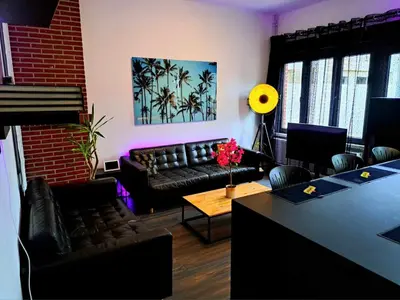 a living room with a couch and a table at petite chambre dans une jolie colocation in Liège