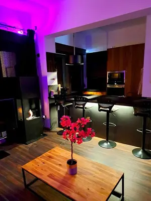 a room with a table with a vase of flowers on it at petite chambre dans une jolie colocation in Liège