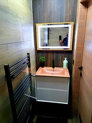 a person taking a picture of a bathroom sink at petite chambre dans une jolie colocation in Liège