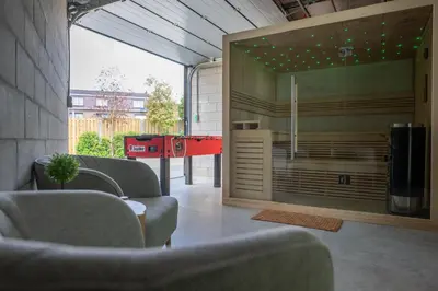 a living room with couches and a red table at NIEUW - De Grenspaal WEST 6P 5 min Maastricht - Sauna - Laadpaal in Riemst
