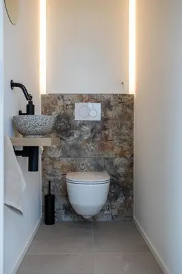 a bathroom with a toilet and a sink at NIEUW - De Grenspaal WEST 6P 5 min Maastricht - Sauna - Laadpaal in Riemst