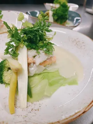a plate of food with fish and vegetables on it at Hoeve de Sterappel in Tongeren