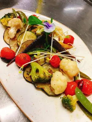a plate of food with vegetables on a table at Hoeve de Sterappel in Tongeren