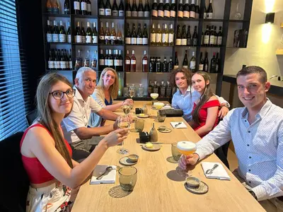 a group of people sitting around a table with wine glasses at Hoeve de Sterappel in Tongeren