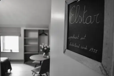 a chalkboard sign hanging on a wall in a room at Hoeve de Sterappel in Tongeren