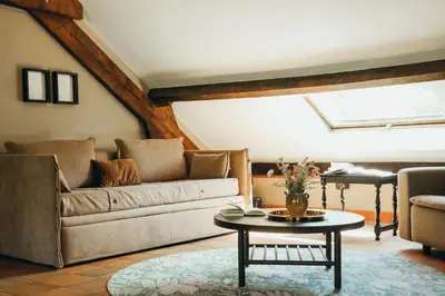 a living room with a couch and a table at La Terrasse du Pré by WelcHome in Verviers