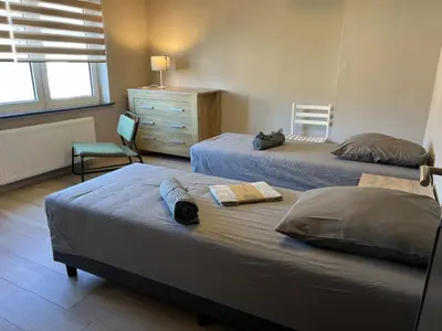 a bedroom with two beds and a dresser at 8P 4B Beautiful house with 4 bedrooms in Hees in Bilzen