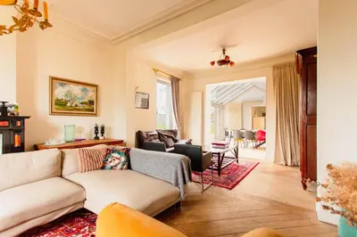 a living room with a couch and a table at Beautiful mansion with swimming pool and jacuzzi in Bilzen