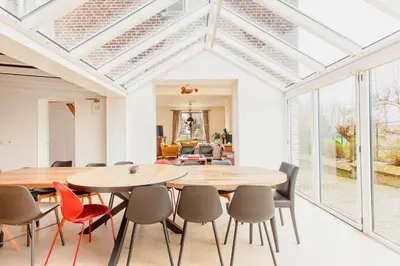 a dining room with a table and chairs at Beautiful mansion with swimming pool and jacuzzi in Bilzen